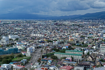 Fototapeta na wymiar View of the suburbs of Hakodate, in northern Japan, with low mountains visible in the distance