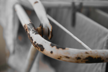 Rusty, worn stainless steel clothes drying rack