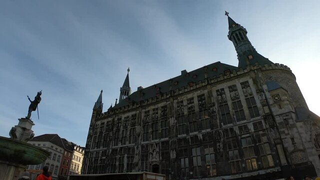 PAN SHOT - The statue of Charlemagne in front of the Aachener Rathaus, the Town Hall of Aachen, built in the Gothic style. Germany, North Rhine-Westphalia.