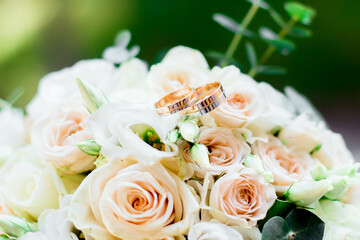 Wedding bouquet for the bride and groom at an event with rings