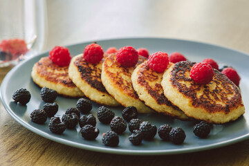 Homemade cheesecakes with blueberries and raspberries.