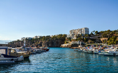 Naklejka premium View of fishing boats and yachts moored in old marina of Antalya, Kaleici, Turkey. Popular tourist place