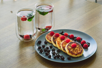 Homemade cheesecakes with blueberries and raspberries.