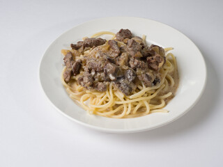 Beef stroganoff with pasta on a plate. Tasty healthy food