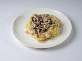 Beef stroganoff with crushed potatoes on a plate. Tasty healthy food