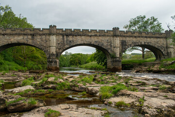 Fototapeta na wymiar Three-arched medieval bridge and river