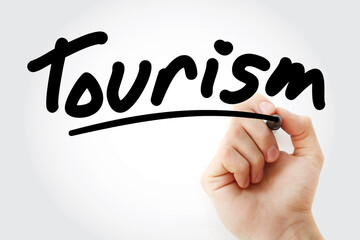 Hand writing Tourism with marker, concept background