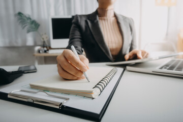 businesswoman hand using smart phone,mobile p payments online shopping,omni channel,digital tablet docking keyboard computer at office in sun light with film grain effect