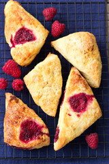 Skones with raspberries for a traditional British afternoon tea party.