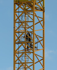 Fototapeta na wymiar crane operator descends from a tower crane at the end of work