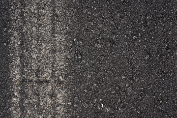 Asphalt with car trail as a background texture.