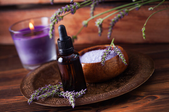 herbal essential oil bottles and fresh lavender flowers
