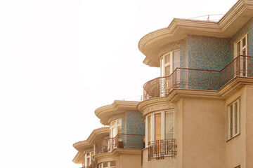 Facade of a residential multi-storey building with summer French balconies