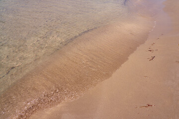Colorful sand on tropical beach as a natural background. Copy space.
