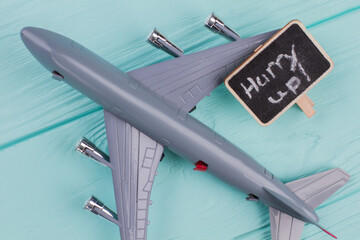Toy airplane and nameplate on it. Extreme close up. Blue wooden desk surface background.