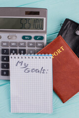 Calculation of the cost of flight and vacation. Number on the calculator and passport is a symbol of the price of travel.