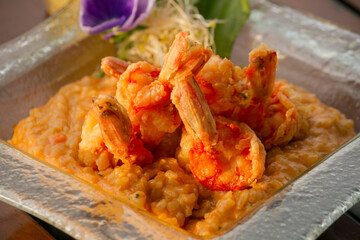 Gourmet seafood. dish presentation. Fried shrimps over mediterranean flavor risotto. 