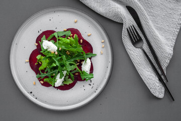 Vegetable salad of fresh beets, arugula, cottage cheese, pine nuts
