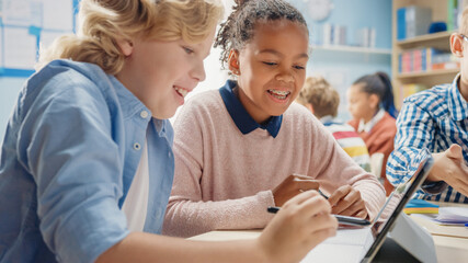 In the Elementary School: Girl and a Boy Work as a Team Using Tablet Computers, Learning Programming Language, Internet Safety and Robotics Design. Progressive Education System