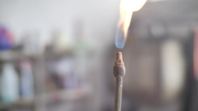 Close up on propane torch nozzle being lightened