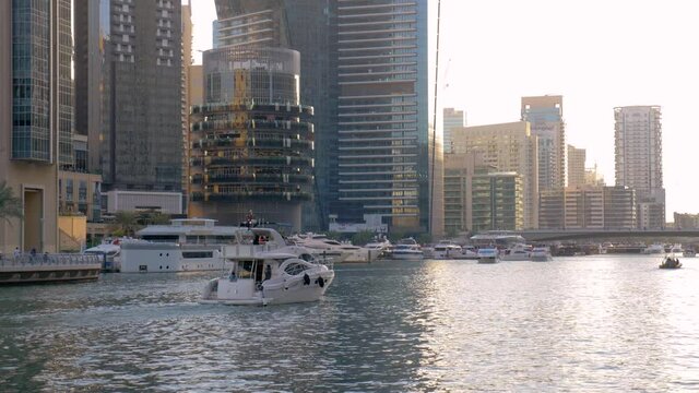 Dubai Marina waterways with private yachts sailing canals, slow motion shot