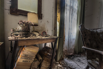 table flowers lamp and a mirror in a room