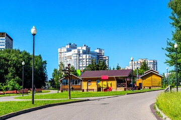 Residential buildings and a small city Park against the blue sky