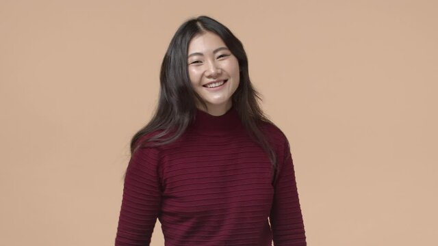 Oh dont mention it, its nothing. Blushing cute silly asian girl receive compliment or praises, show stop it you gesture and smiling, shaking head embarrassed and happy, waving away hand