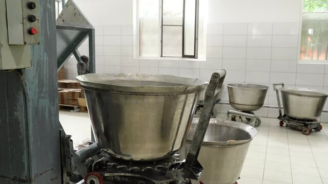 mass for cooking halva raise bowl up and poured onto a conveyor belt.