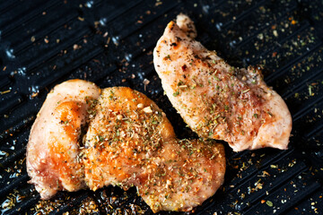 Grilled chicken in a grill with spice.