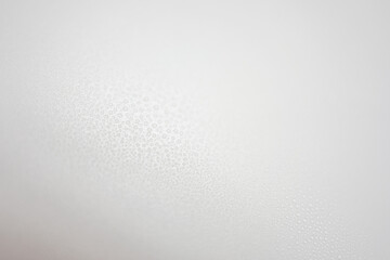 Different drops of water on a vinyl background with a gradient of gray color. Soft focus, macro.