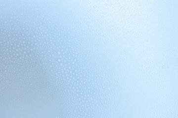 Different drops of water on a vinyl background with a blue and white gradient. Soft focus, macro.