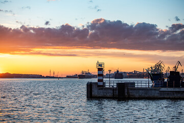 Lighthouse and cranes at sunset in port of Klaipeda, Lithuania