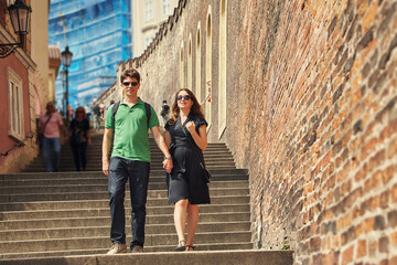 young couple in love walking on a street of European city. sightseeing traveler. Prague, Czech Republic.