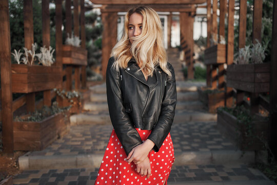 Blond young woman on red dress wild hair 