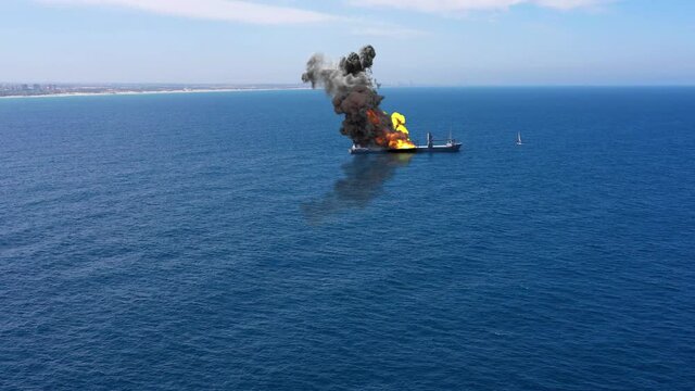 Cargo ship burning on fire with large scale smoke-Aerial
Aerial, Mediterranean Sea, Cargo tanker ship, Real Drone view with visual effect Elements 
