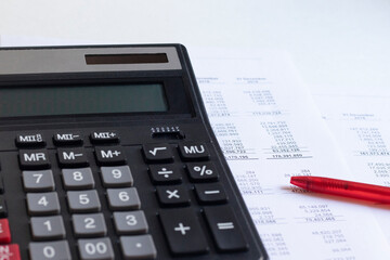 Accounting business concept. Calculator with financial statements and financial statements on the table.