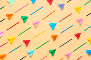 Back to school concept. Colorful pencils and paper airplanes pattern