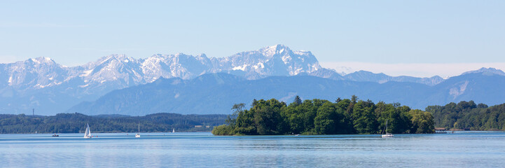 Upper bavarian landscape with Roseninsel (rose island) and Zugspitze mountain. Scenic panorama.