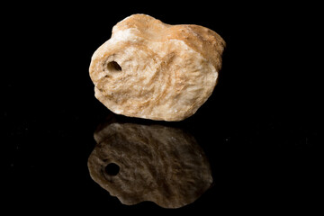 Beautiful Stalactite cut pattern inside structure for science and geology isolated on black background with reflection. Close up.