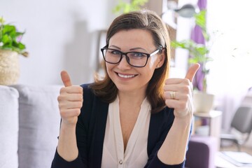 Video call, video conference, business woman looking at webcam, shows thumbs up gesture ok sign