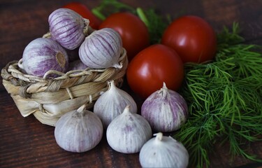 garlic in a small wicker basket, tomatoes and dill