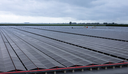 Solar photovoltaic modules during sunset and after rain in power plant, Netherlands