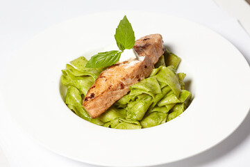 Salmon steak with pasta and fresh basil