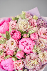 Beautiful bouquet of mixed flowers in woman hand. Floral shop concept . Handsome fresh bouquet. Flowers delivery.