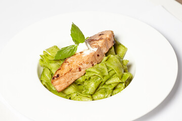 Salmon steak with pasta and fresh basil