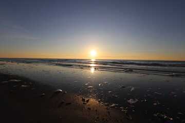 Fototapeta premium View of a beautiful sunset with beautiful colors over the sea with reflecting sun.