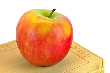 Red apple on a wooden board. Red apple isolated on white background.