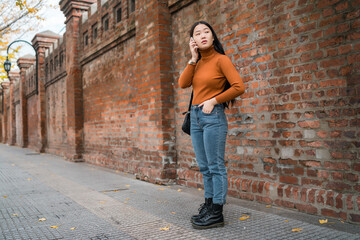 Asian woman talking on the phone.