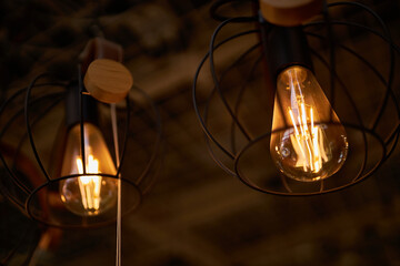 Edison loft style lamp with bokeh light background. Edison lamp, closeup photo. Edison lamp on...